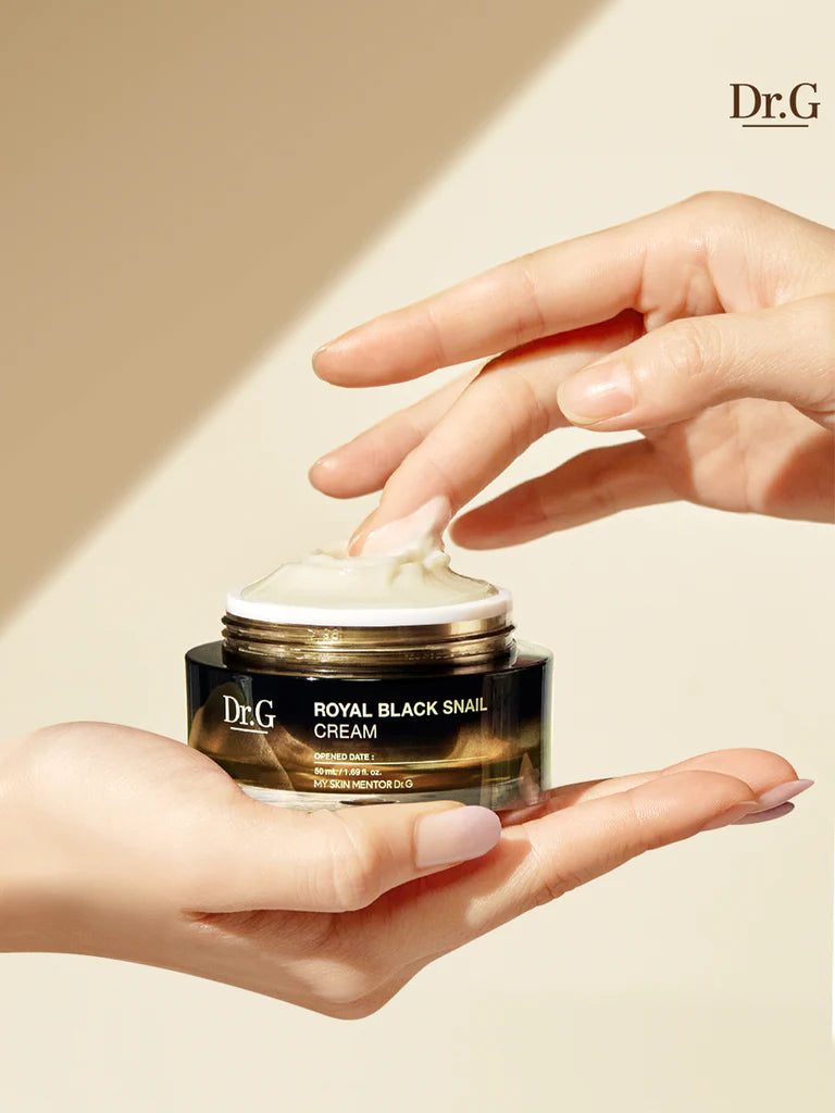 Hands applying DR.G Royal Black Snail Cream – creamy texture, hydrating formula used as a soft sleeping mask for nourished skin
